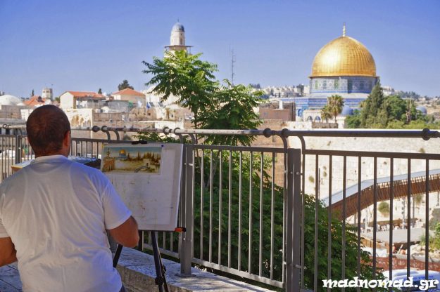 Painting the skyline of the troubled Jerusalem Old City with the Muslim Dome of the Rock standing out above the Jewish Western Wall.
